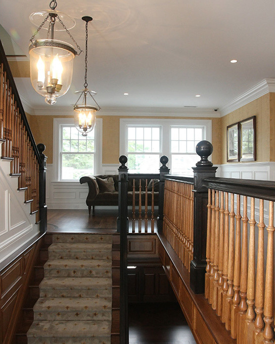 Design ideas for a large classic carpeted straight wood railing staircase in Other with carpeted risers.