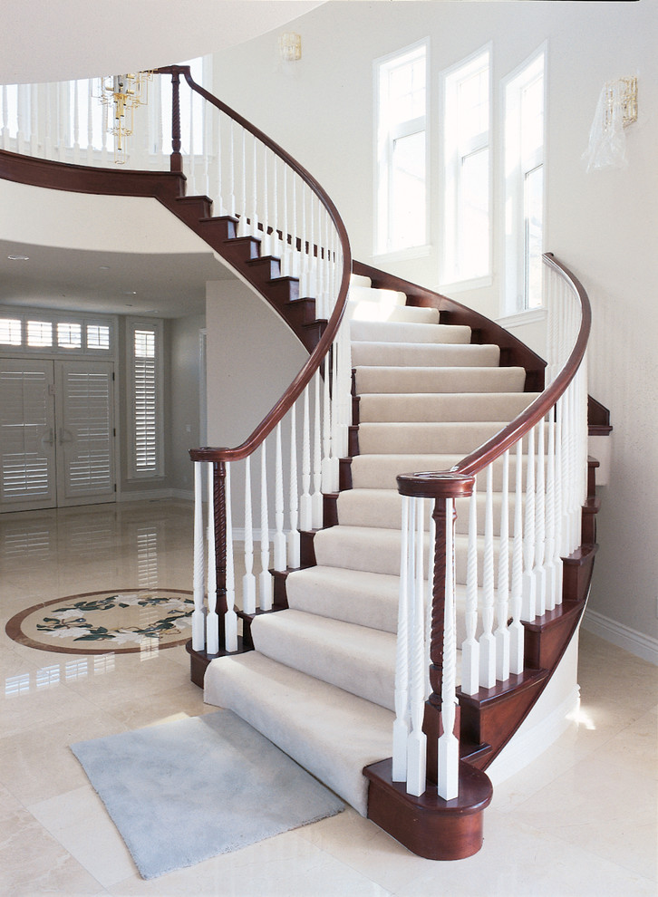 Inspiration for a large timeless wooden curved staircase remodel in San Francisco with wooden risers