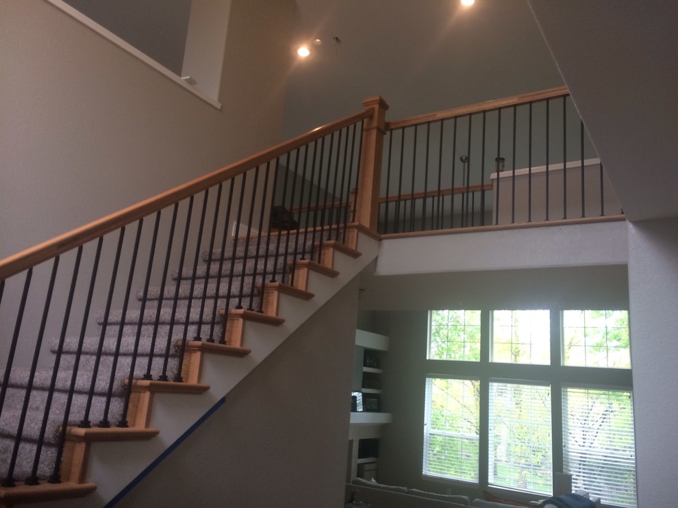 Example of a straight staircase design in Denver with carpeted risers
