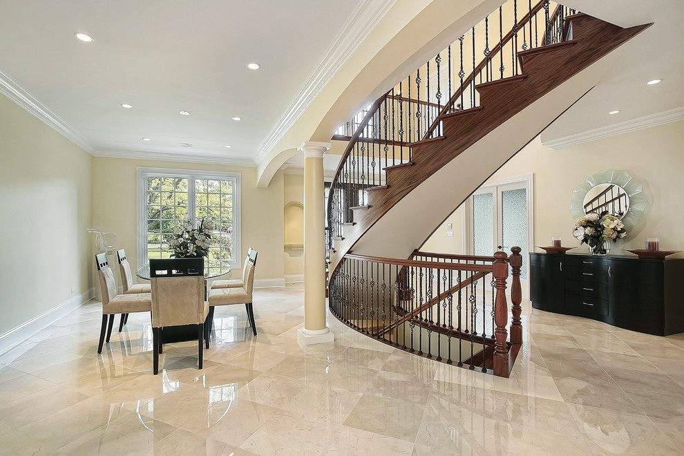 This is an example of an expansive traditional wood l-shaped staircase in New York with wood risers.