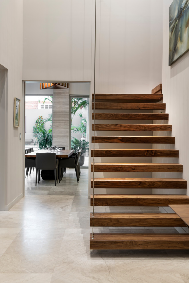 Large trendy wooden floating metal railing staircase photo in Perth