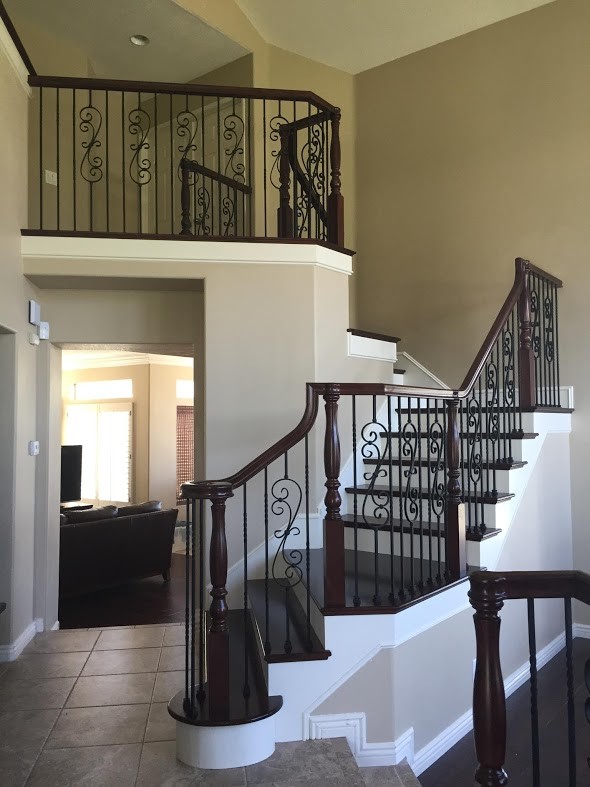 This is an example of a medium sized contemporary wood curved wood railing staircase in Los Angeles with painted wood risers.