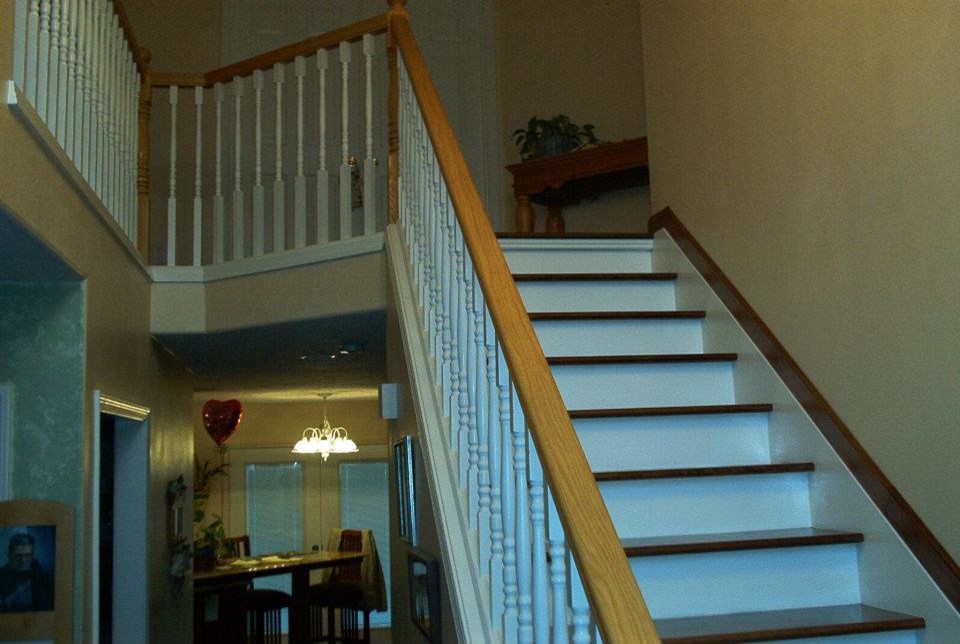 Inspiration for a mid-sized timeless wooden straight staircase remodel in Portland with painted risers