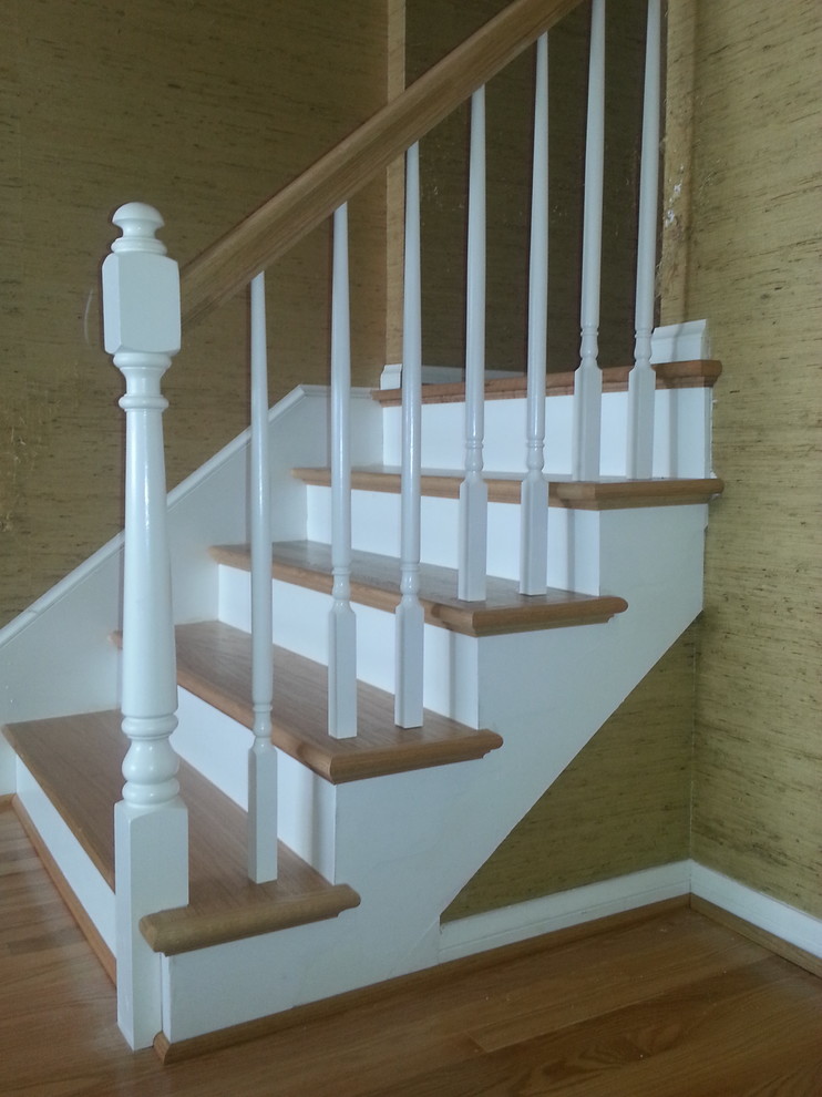 Example of a small classic wooden straight staircase design in Other with painted risers