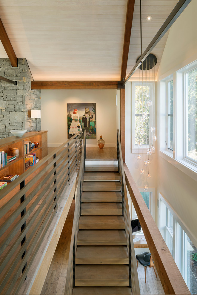 Example of a large trendy wooden straight open and wood railing staircase design in Other