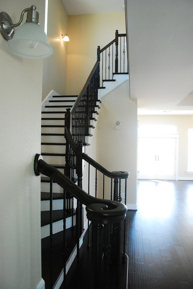 Mid-sized elegant wooden curved staircase photo in Houston with painted risers