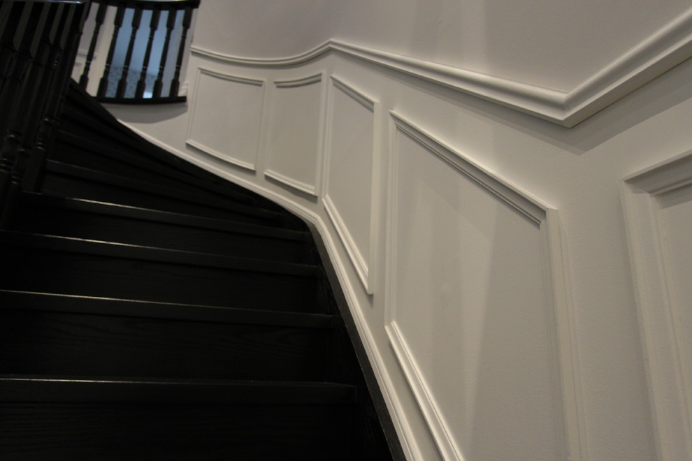 This is an example of a medium sized modern wood curved staircase in Toronto with wood risers.