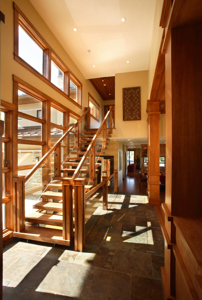 На фото: большая прямая деревянная лестница в современном стиле с деревянными ступенями и стеклянными перилами с
