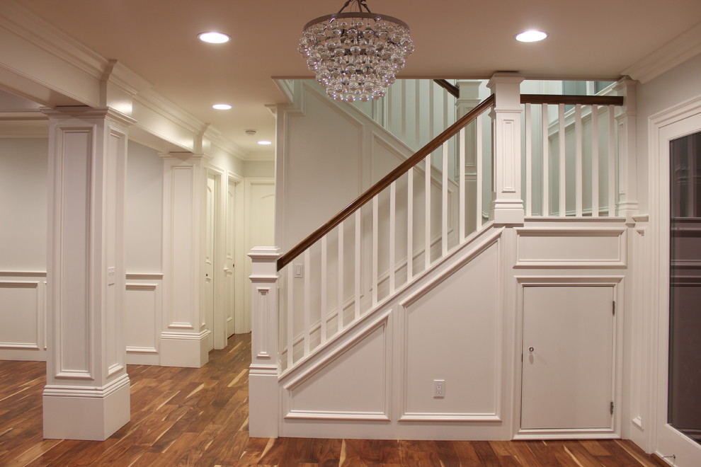 Medium sized classic l-shaped wood railing staircase in Los Angeles with feature lighting.