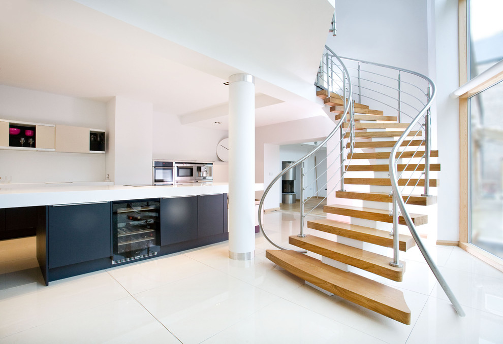 Photo of a contemporary curved staircase in London with open risers.