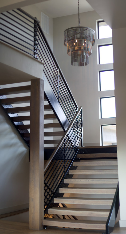 Пример оригинального дизайна: п-образная лестница среднего размера в современном стиле с деревянными ступенями и металлическими перилами без подступенок