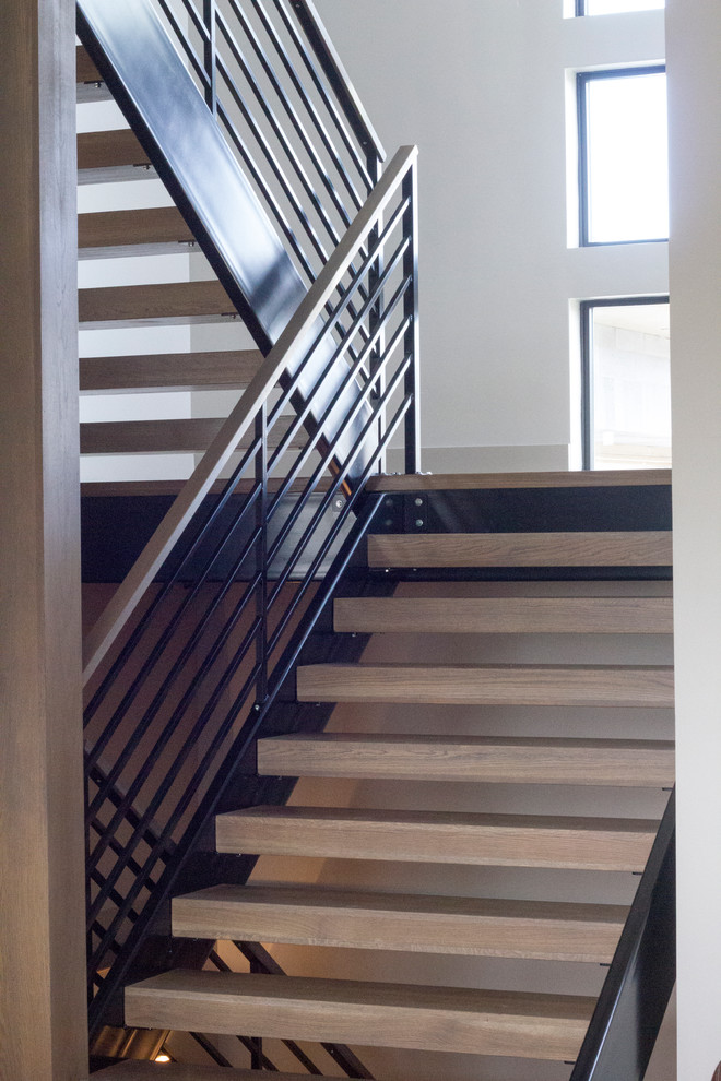 Staircase - mid-sized contemporary wooden u-shaped open and metal railing staircase idea in Boise