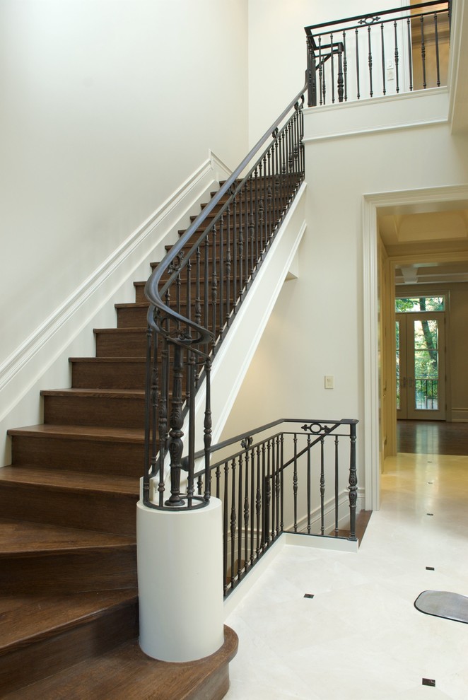 Inspiration for a large mediterranean wood l-shaped metal railing staircase in Toronto with wood risers.