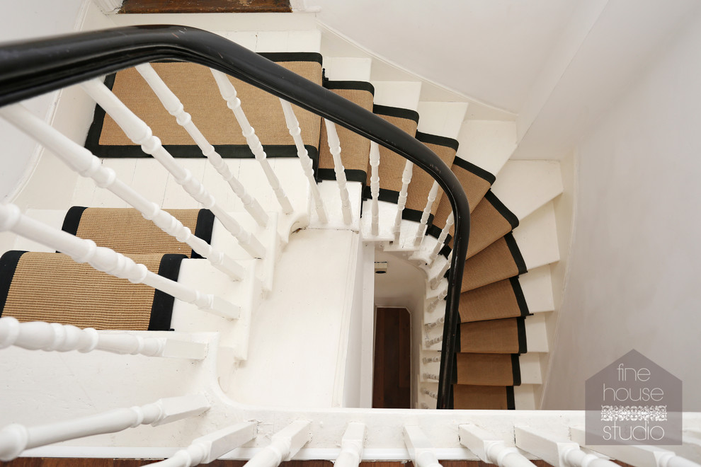 Idée de décoration pour un grand escalier peint tradition en U avec des marches en bois peint.