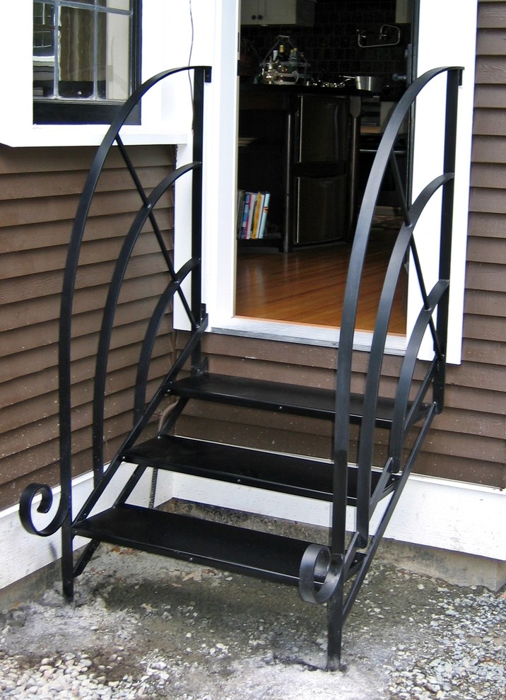 Inspiration for a small modern metal straight metal railing staircase in Vancouver with open risers.