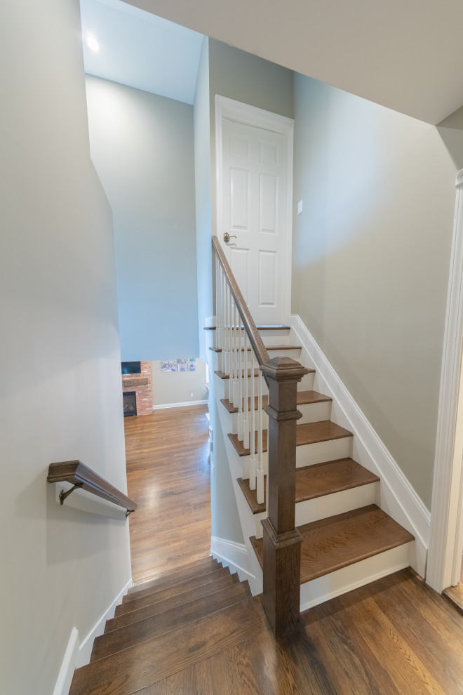 Design ideas for a classic wood wood railing staircase in New York with wood risers.