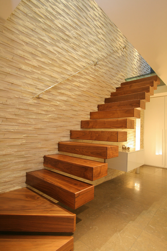 Photo of a contemporary wood l-shaped staircase in London with open risers.