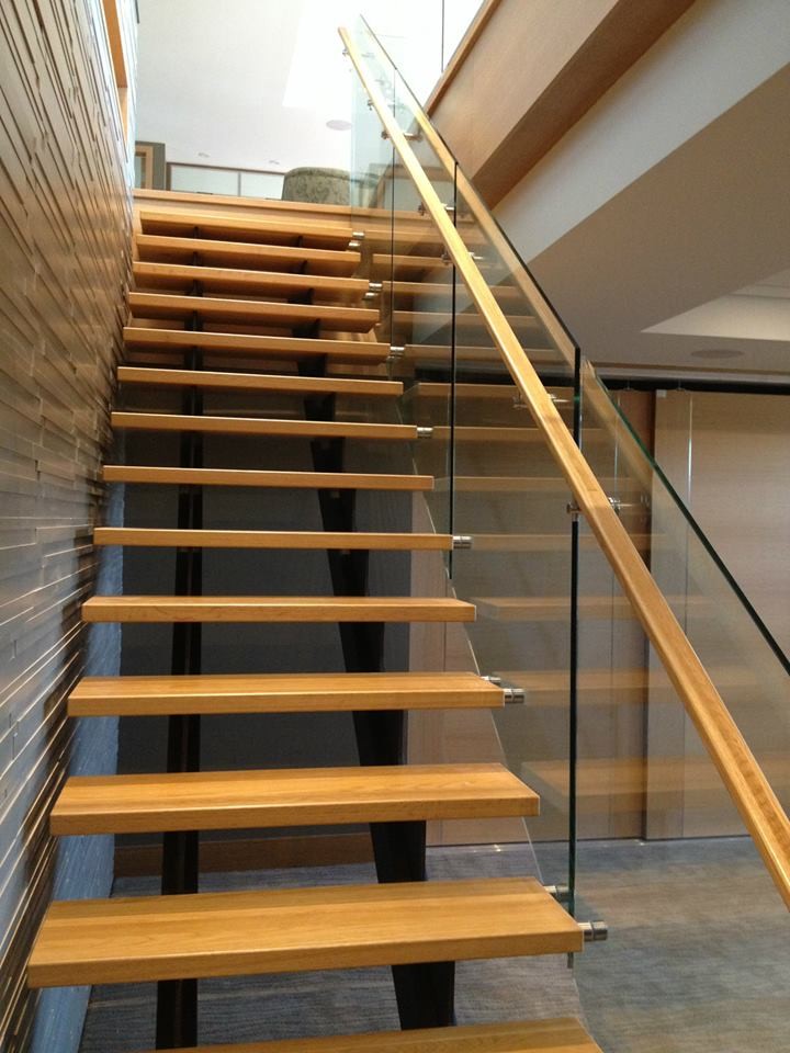 Design ideas for a medium sized contemporary wood straight glass railing staircase in Other with open risers.