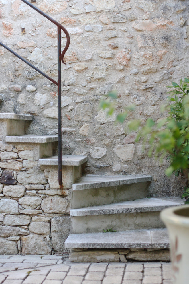 Modelo de escalera exterior mediterránea con escalones de piedra caliza y contrahuellas de piedra caliza