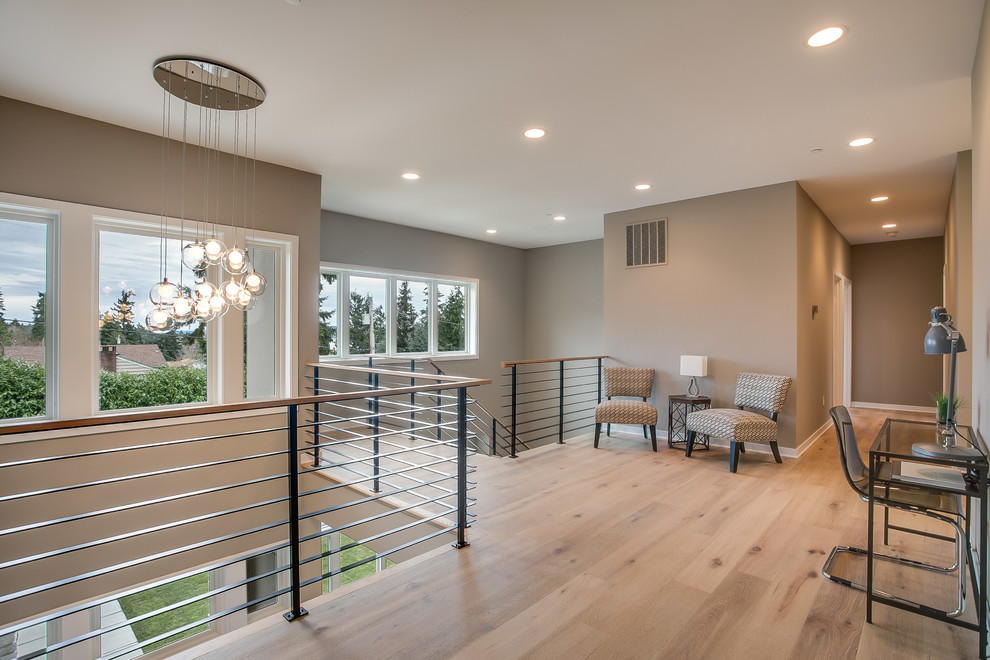 Design ideas for a large contemporary wood floating metal railing staircase in Seattle with open risers and feature lighting.