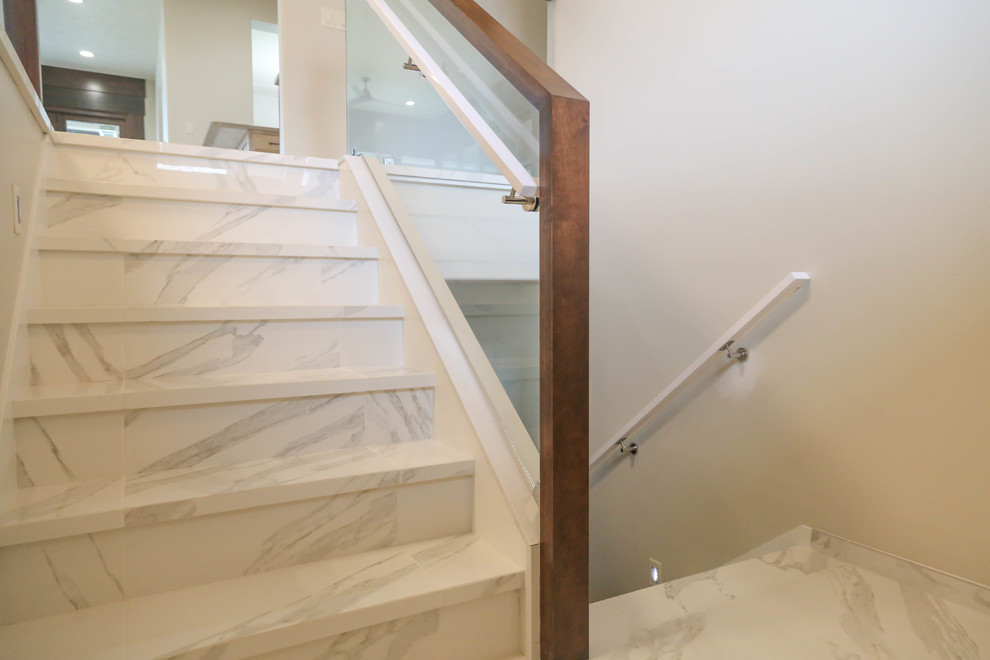Example of a mid-sized trendy tile u-shaped mixed material railing staircase design in Other with tile risers