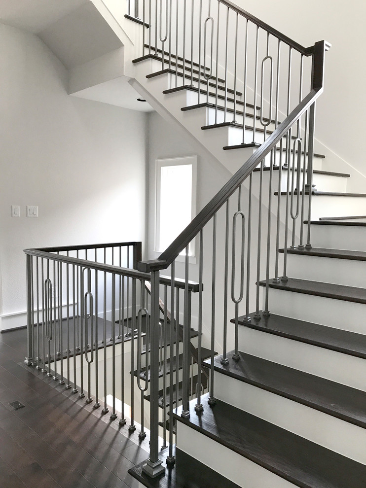 Inspiration for a large contemporary wooden u-shaped staircase remodel in Houston with wooden risers