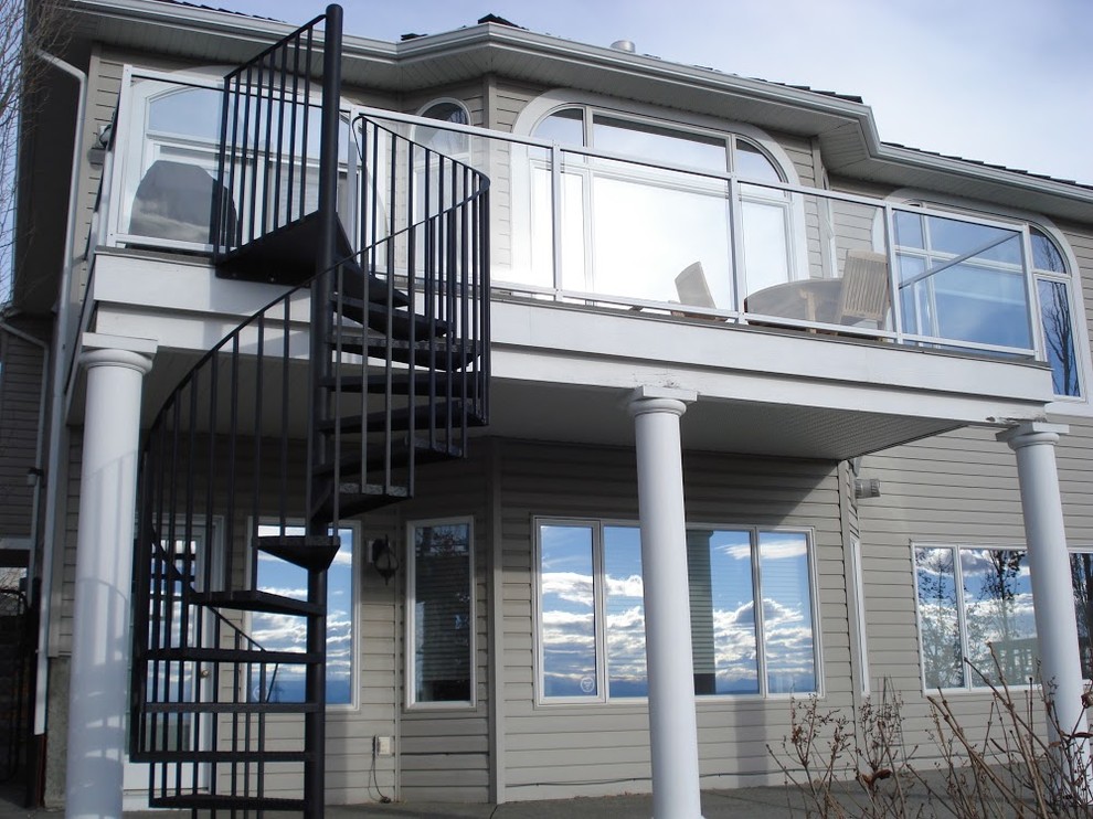 Example of a mid-sized trendy metal spiral open staircase design in Calgary