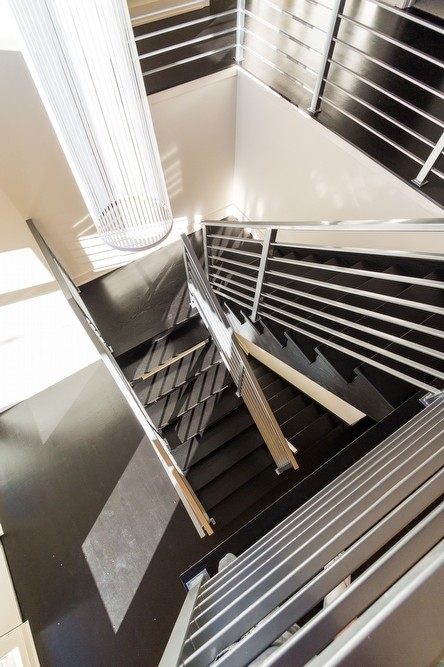Example of a large trendy wooden u-shaped metal railing staircase design in Boston with wooden risers