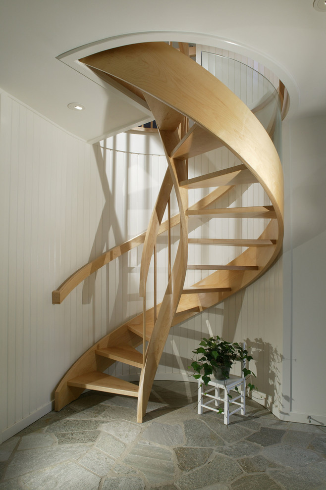 Inspiration for a contemporary wood curved staircase in Detroit with open risers.