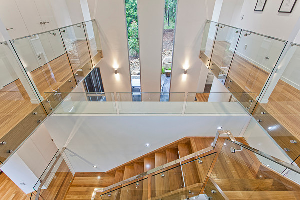 This is an example of a modern wood floating staircase in Brisbane with wood risers.