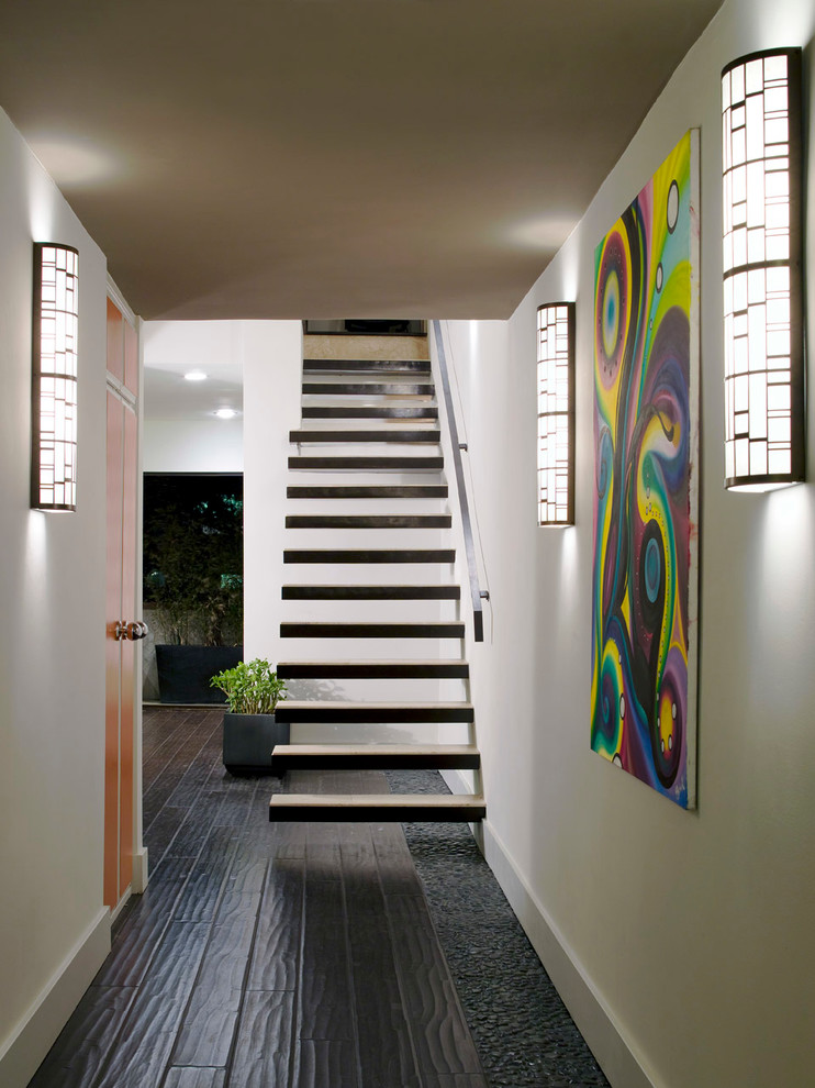 This is an example of a contemporary floating staircase in Los Angeles with open risers.