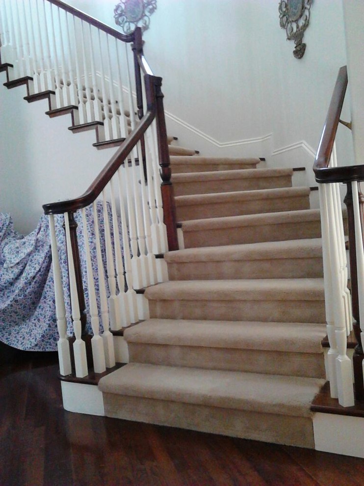 Photo of a medium sized classic wood l-shaped staircase in San Francisco with carpeted risers.