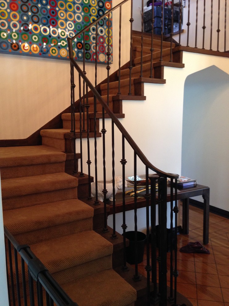 Inspiration for a mid-sized mediterranean wooden u-shaped staircase remodel in Los Angeles with wooden risers
