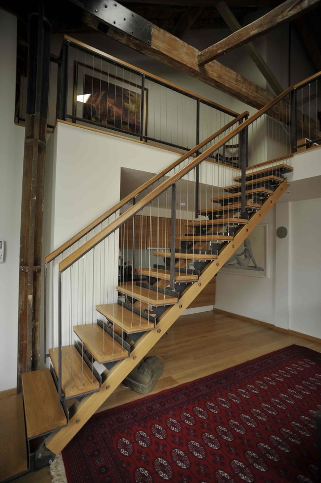 Design ideas for a medium sized contemporary wood straight staircase in London with open risers.