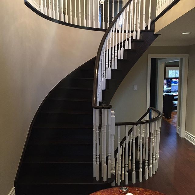 Medium sized traditional wood curved staircase in Toronto with wood risers.
