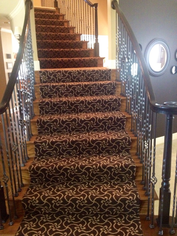 Photo of a medium sized contemporary carpeted curved staircase in Kansas City with carpeted risers.