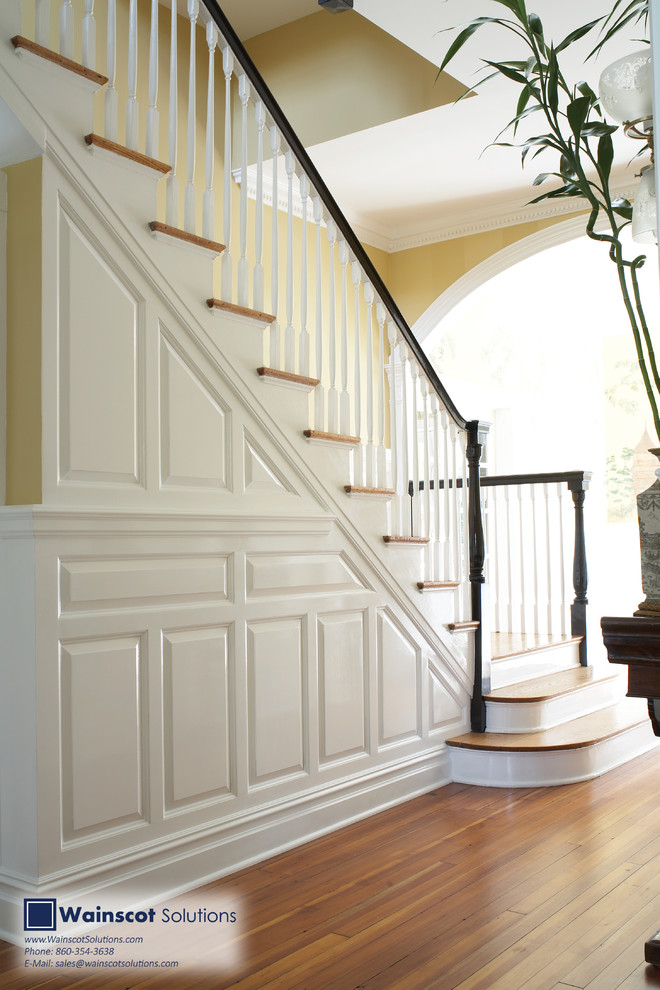 Example of a large classic wooden straight staircase design in New York with wooden risers