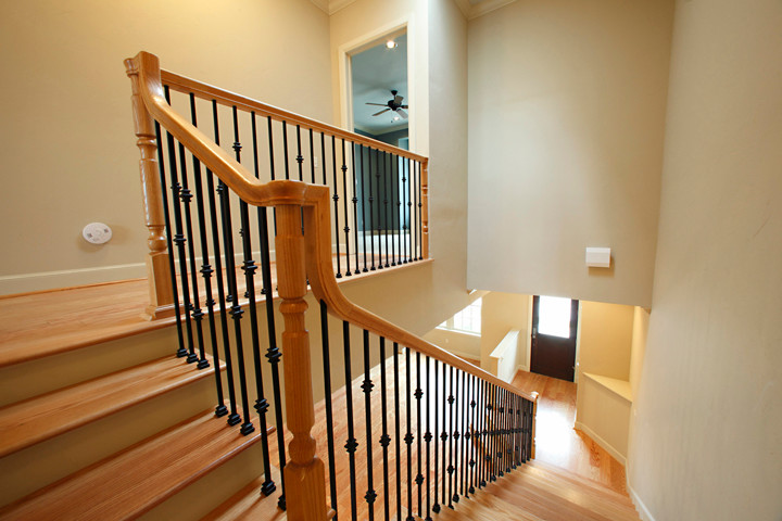 Inspiration for a large classic wood staircase in Oklahoma City with wood risers.