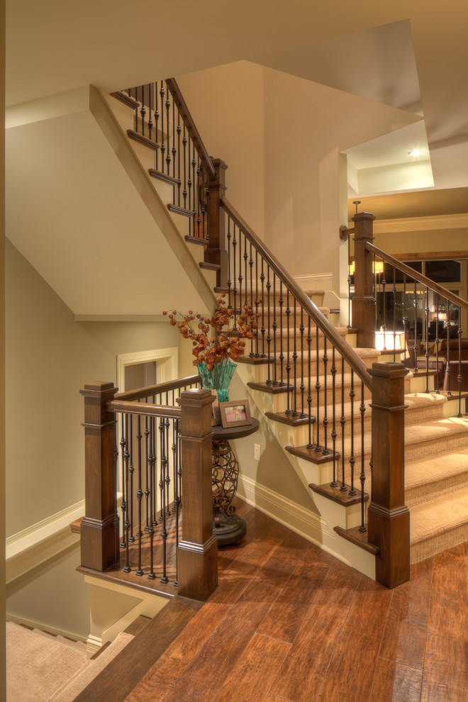 Mid-sized elegant carpeted l-shaped wood railing staircase photo in Other with carpeted risers