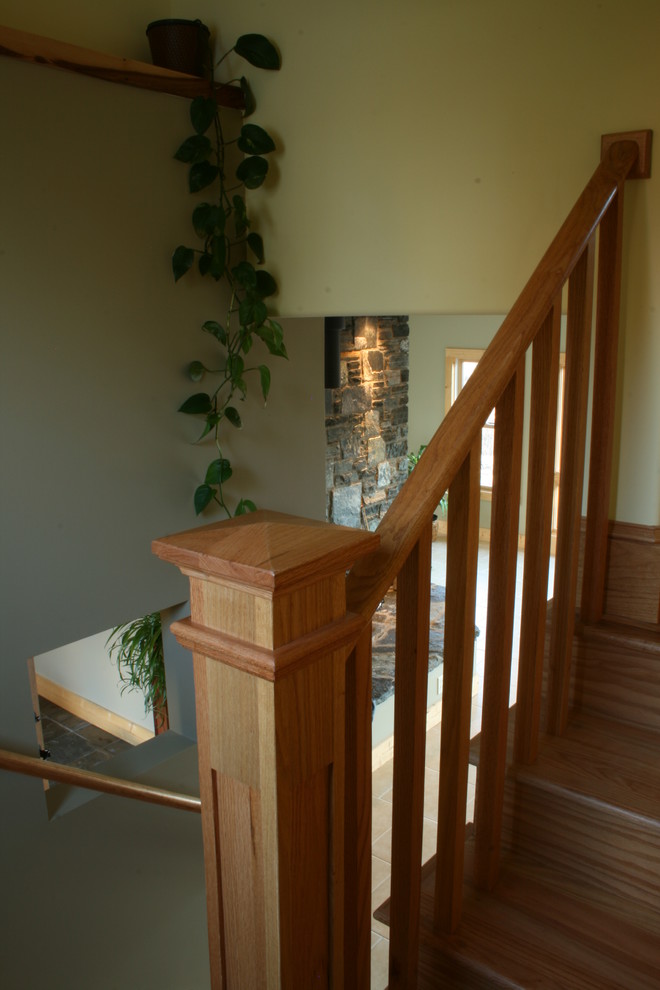 На фото: п-образная деревянная лестница среднего размера в классическом стиле с деревянными ступенями и деревянными перилами