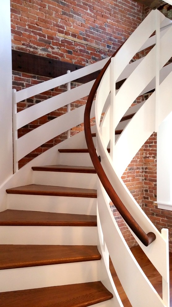 Modelo de escalera curva de estilo americano de tamaño medio con escalones de madera y contrahuellas de madera pintada