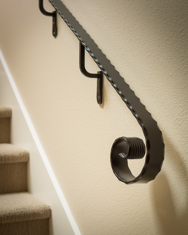 Photo of a mediterranean carpeted straight metal railing staircase in San Francisco with carpeted risers.