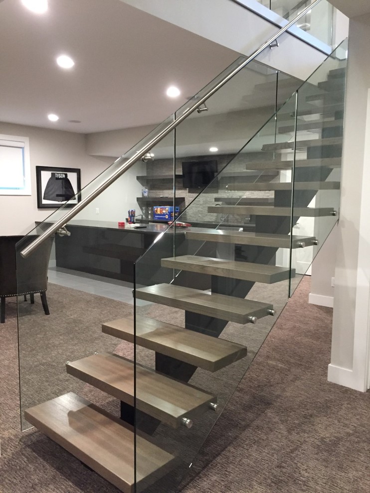 This is an example of a medium sized contemporary wood straight staircase in Calgary with open risers.