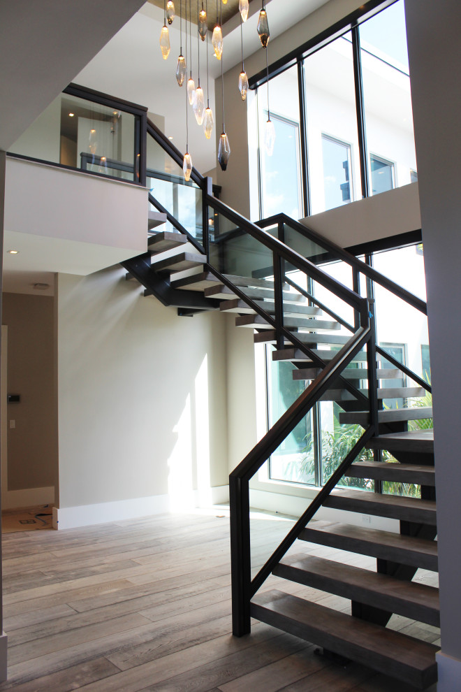 Cette image montre un escalier sans contremarche traditionnel de taille moyenne avec des marches en bois et un garde-corps en matériaux mixtes.