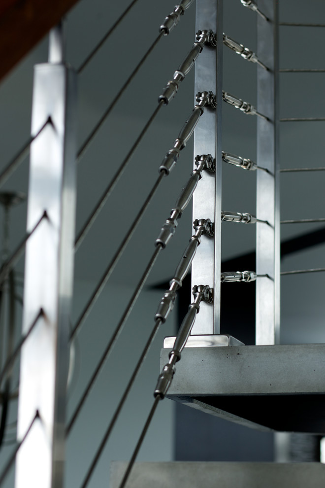 steel mono stringer with concrete treads Modern Staircase