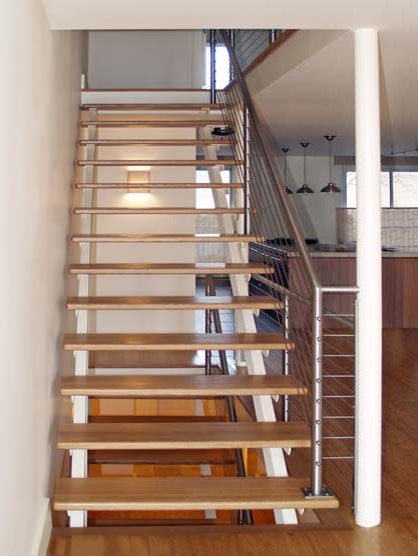 This is an example of an urban wood straight wire cable railing staircase in New York.