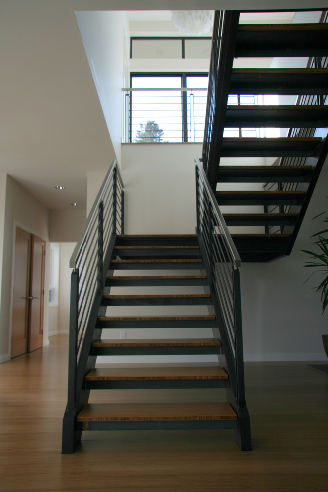 Large minimalist wooden u-shaped open staircase photo in Seattle