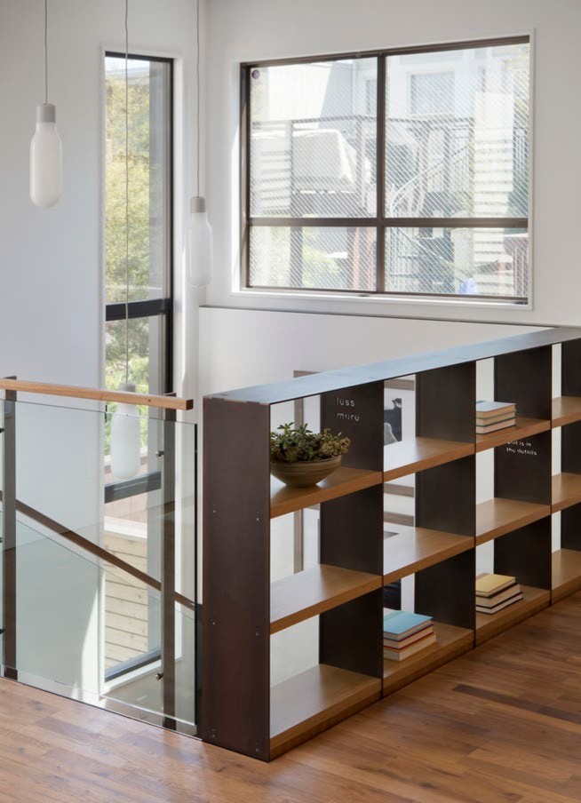Example of a large minimalist wooden u-shaped open and wood railing staircase design in San Francisco