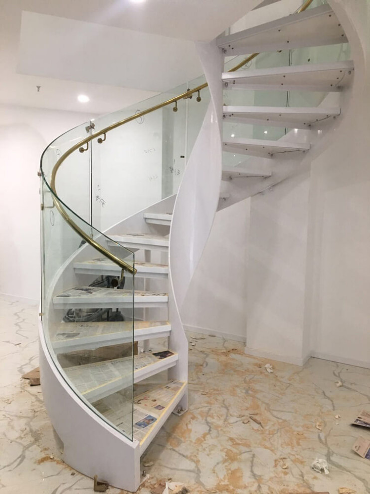 Design ideas for a small modern wood curved glass railing staircase in Detroit with open risers.