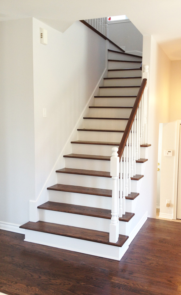 Medium sized traditional wood straight staircase in Montreal with painted wood risers.